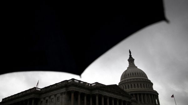 A view of the U.S. Capitol, silhouetted by an umbrella during a storm on Capitol Hill in Washington, U.S., March 17, 2022. - Sputnik International