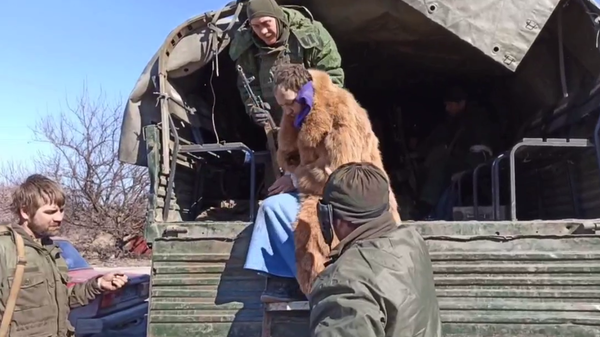 Captured suspected Ukrainian serviceman or Azov fighter attempting to flee Mariupol conflict zone dressed in women's clothing. Screengrab. - Sputnik International