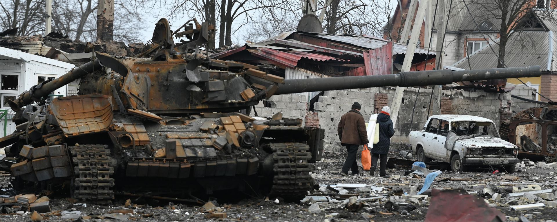 Local residents pass by the destroyed tank of the Ukrainian armed forces in the city of Volnovakha that came under control of the Donetsk People's Republic, in Donetsk People's Republic. Local residents pass by the destroyed tank of the Ukrainian armed forces in the city of Volnovakha that came under control of the Donetsk People's Republic, in Donetsk People's Republic. - Sputnik International, 1920, 30.04.2022