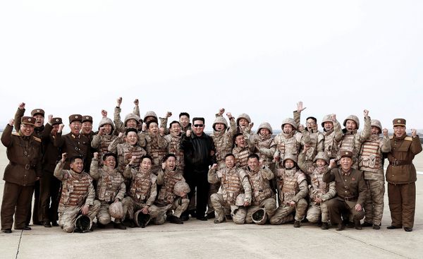 This picture taken on 24 March 2022 and released by North Korea's official Korean Central News Agency (KCNA) on 25 March 2022 shows North Korean leader Kim Jong-un (C) posing with North Korean military personnel after they took part in the test launch of a new type of Intercontinental Ballistic Missile (ICBM) Hwasong-17 of North Korea's strategic forces in an undisclosed location in North Korea. - Sputnik International
