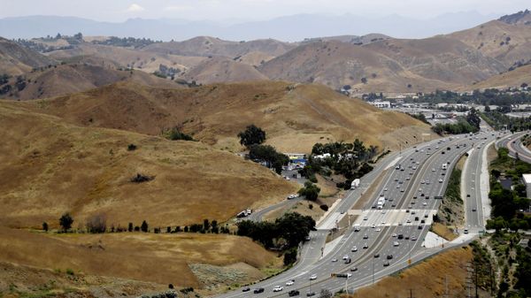 FILE - U.S. Highway 101 passes between two separate open space preserves on conservancy lands in the Santa Monica Mountains in Agoura Hills, Calif., July 25, 2019. Groundbreaking is set for next month on what will be the world's largest wildlife crossing, a bridge over a major Southern California highway that will provide more room to roam for mountain lions and other animals hemmed in by urban sprawl. A ceremony marking the start of construction for the span over U.S. 101 near Los Angeles will take place on Earth Day, April 22, the National Wildlife Federation announced on Thursday, March 24, 2022. - Sputnik International