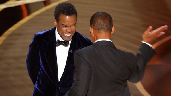 Will Smith (R) hits Chris Rock as Rock spoke on stage during the 94th Academy Awards in Hollywood, Los Angeles, California, U.S., March 27, 2022 - Sputnik International