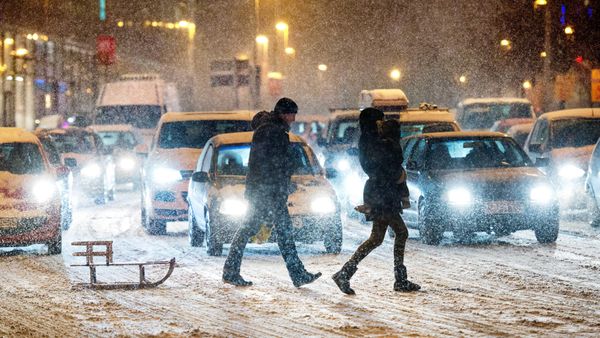 A young family with a sled crosses the street during heavy snowfall in Hannover, northern Germany, Monday, Jan. 21, 2013. (AP Photo/dpa, Julian Stratenschulte) - Sputnik International