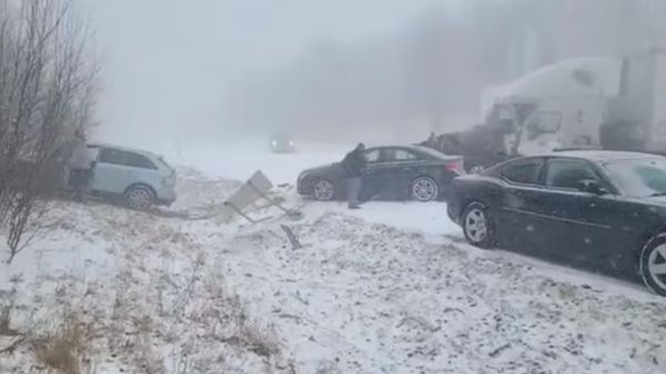 An out-of-control vehicle approaches a driver that stepped out, amid a pileup during snow and fog on I-81 North, in Schuylkill County, Pennsylvania, U.S., March 28, 2022 - Sputnik International