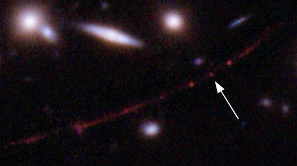 This image made available by NASA on Wednesday, March 30, 2022, shows the star Earendel, indicated by arrow, and the Sunrise Arc galaxy, stretching from lower left to upper right, optically bent due to a massive galaxy cluster between it and the Hubble Space Telescope which captured the light. The mass of the galaxy cluster serves as a magnifying glass, allowing Earendel to be seen. - Sputnik International
