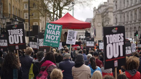 Demonstrators hold placards as they attend a protest, outside the gates of Downing Street, against the increase of the cost of living, in London, Saturday, April 2, 2022. - Sputnik International