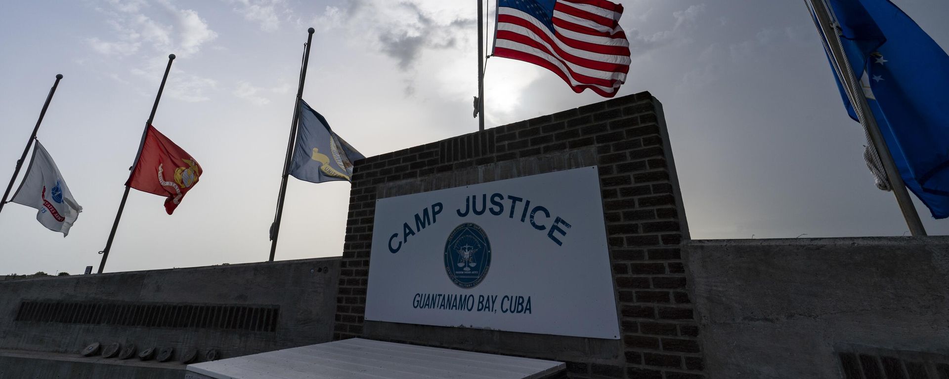 In this photo reviewed by U.S. military officials, flags fly at half-staff at Camp Justice, Aug. 29, 2021, in Guantanamo Bay Naval Base, Cuba. The Defense Department says Sufiyan Barhoumi, an Algerian man imprisoned at the Guantanamo Bay detention center for nearly 20 years, has been released and sent back to his homeland. In this photo reviewed by U.S. military officials, flags fly at half-staff at Camp Justice, Aug. 29, 2021, in Guantanamo Bay Naval Base, Cuba. The Defense Department says Sufiyan Barhoumi, an Algerian man imprisoned at the Guantanamo Bay detention center for nearly 20 years, has been released and sent back to his homeland. - Sputnik International, 1920, 02.02.2023