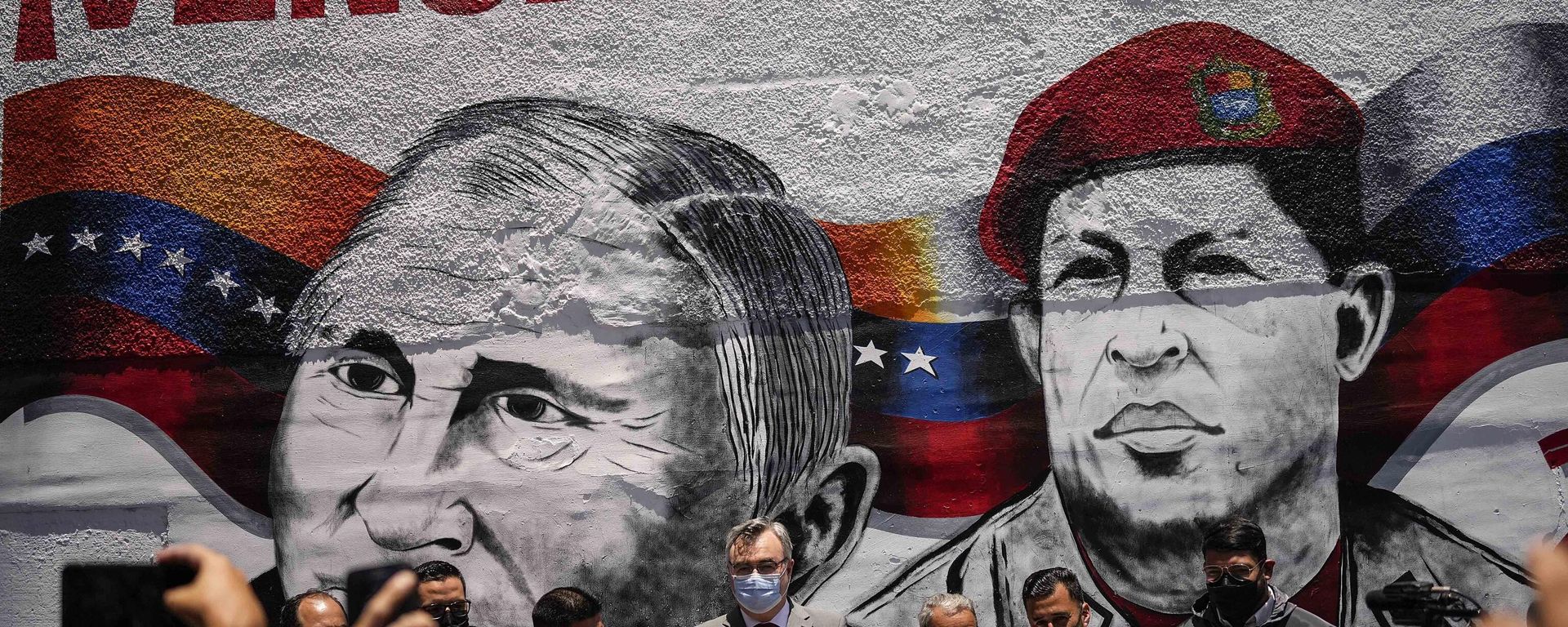 Russian Ambassador to Venezuela, Sergey Melik Bagdasarov, center, stands in front of a mural featuring Russian President Vladimir Putin and the late President Hugo Chavez, during an event to inaugurate a basketball and soccer venue, in the Catia neighborhood of Caracas, Venezuela, Saturday, April 2, 2022. Russian Ambassador to Venezuela, Sergey Melik Bagdasarov, center, stands in front of a mural featuring Russian President Vladimir Putin and the late President Hugo Chavez, during an event to inaugurate a basketball and soccer venue, in the Catia neighborhood of Caracas, Venezuela, Saturday, April 2, 2022. - Sputnik International, 1920, 17.08.2022