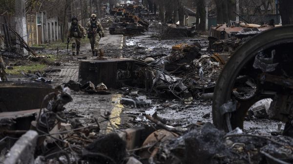 Soldiers walk amid destroyed Russian tanks in Bucha, on the outskirts of Kyiv, Ukraine, Sunday, April 3, 2022. - Sputnik International