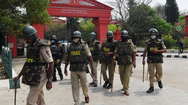 Police personnel stand in front of the Karnataka High Court in Bangalore on March 15, 2022, after the court upheld a local ban on the hijab in classrooms, weeks after the edict stoked violent protests and renewed fears of discrimination against the country's Muslim minority. - Sputnik International