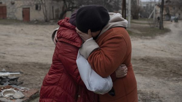 Elderly women cry as they stand near a residential building destroyed by the shelling, in Shchastia, Lugansk People's Republic. - Sputnik International