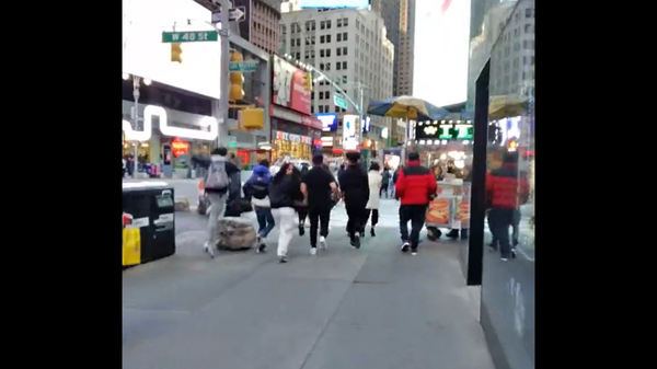 Screenshot captures the moment on April 10, 2022, in which an explosion sounded in Times Square, New York City, and sent dozens of tourists and bystanders fleeing the area. Officials later determined that the explosion was caused by a manhole fire. - Sputnik International