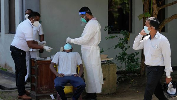 A Sri Lankan health worker collects a swab sample of a man to test for COVID-19 in Colombo, Sri Lanka - Sputnik International