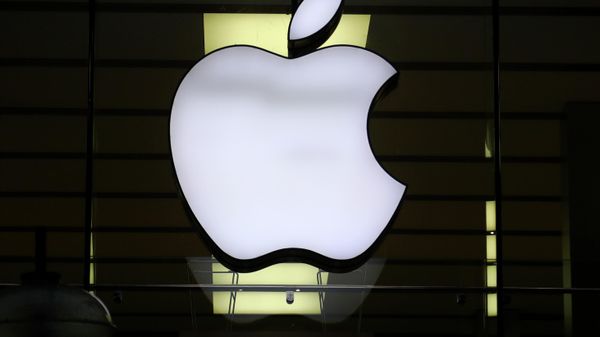 In this Wednesday, Dec. 16, 2020 file photo, the logo of Apple is illuminated at a store in the city center in Munich, Germany. Apple said late Wednesday Sept. 1, 2021, it is relaxing rules to allow some app developers such as Spotify, Netflix and digital publishers to include an outside link so users can sign up for paid subscription accounts.  - Sputnik International