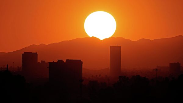 Buildings in downtown Phoenix are silhouetted at sunset, Friday, April 1, 2022, in Phoenix. (AP Photo/Charlie Riedel) - Sputnik International