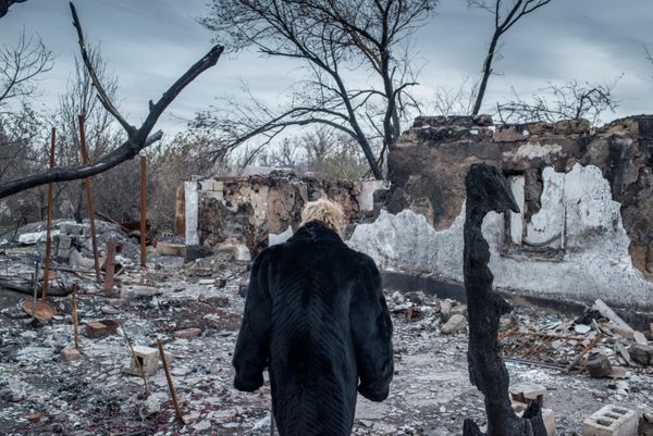 A woman near a destroyed house in the village of Sakhanka, situated in the southern Donetsk People’s Republic on the line of contact between DPR militia and Ukrainian forces. Ukrainian forces have levelled thousands of homes and apartment buildings in Donbass through artillery and air strikes over the past eight years. The people who inhabited them have been left with nothing. - Sputnik International