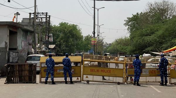 Riot policemen stand guard next to a barricade set up near a mosque and a temple a day after communal clashes in Jahangirpuri, a neighborhood in northwest Delhi, Sunday, April 17, 2022. Police in India's capital have arrested 14 people after communal violence broke out during a Hindu religious procession, leaving several injured. Riot policemen stand guard next to a barricade set up near a mosque and a temple a day after communal clashes in Jahangirpuri, a neighborhood in northwest Delhi, Sunday, April 17, 2022. Police in India's capital have arrested 14 people after communal violence broke out during a Hindu religious procession, leaving several injured. - Sputnik International