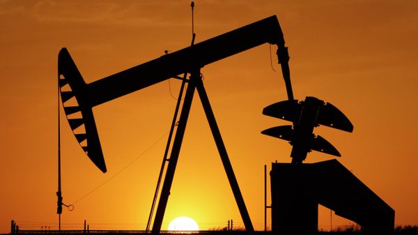 A pump jack is silhouetted against the setting sun in Oklahoma City on March 22, 2012. - Sputnik International