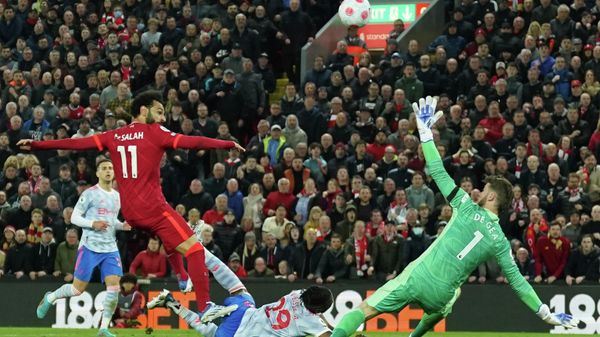 Liverpool's Mohamed Salah, left, scores his side's fourth goal during the English Premier League soccer match between Liverpool and Manchester United at Anfield stadium in Liverpool, England, Tuesday, April 19, 2022. Liverpool's Mohamed Salah, left, scores his side's fourth goal during the English Premier League soccer match between Liverpool and Manchester United at Anfield stadium in Liverpool, England, Tuesday, April 19, 2022. - Sputnik International