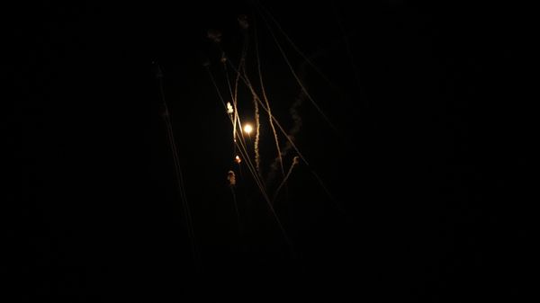 Israel's Iron Dome air defense system launches missiles to intercept rockets fired from the Gaza Strip toward Israel, over Gaza City, early Thursday, April 21, 2022. - Sputnik International