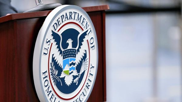 A U.S. Department of Homeland Security plaque is displayed a podium as international passengers arrive at Miami international Airport where they are screened by U.S. Customs and Border Protection, Nov. 20, 2020, in Miami - Sputnik International