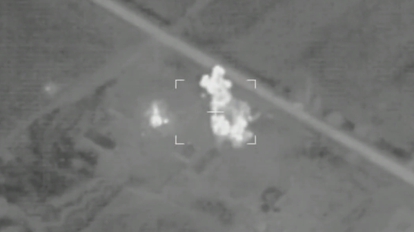 Screengrab of Russian MoD video of precision artillery strike on Ukrainian ammo depot. - Sputnik International