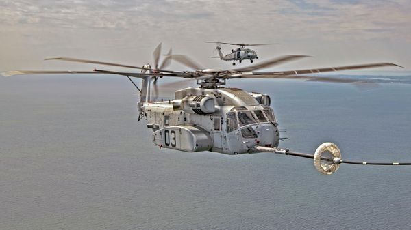 The CH-53K King Stallion successfully plugs into a funnel-shaped drogue towed behind a KC-130J during aerial refueling wake testing over the Chesapeake Bay. Photo by Erik Hildebrandt. - Sputnik International