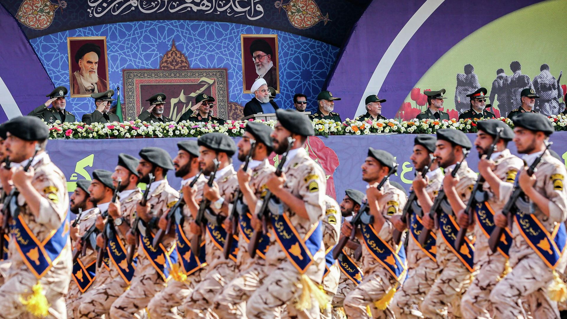 A handout picture provided by the Iranian presidency on September 22, 2019 shows President Hassan Rouhani (C) and other top military commanders watching members the Islamic Revolutionary Guard Corps (IRGC) marching past during the annual Sacred Defence Week military parade marking the anniversary of the outbreak of the devastating 1980-1988 war with Saddam Hussein's Iraq, in the capital Tehran. - Rouhani said on September 22 that the presence of foreign forces creates insecurity in the Gulf, after the US ordered the deployment of more troops to the region. Foreign forces can cause problems and insecurity for our people and for our region, Rouhani said in a televised speech at the annual military parade, adding that Iran would present to the UN a regional cooperation plan for peace. (Photo by Iranian Presidency / AFP) A handout picture provided by the Iranian presidency on September 22, 2019 shows President Hassan Rouhani (C) and other top military commanders watching members the Islamic Revolutionary Guard Corps (IRGC) marching past during the annual Sacred Defence Week military parade marking the anniversary of the outbreak of the devastating 1980-1988 war with Saddam Hussein's Iraq, in the capital Tehran. - Rouhani said on September 22 that the presence of foreign forces creates insecurity in the Gulf, after the US ordered the deployment of more troops to the region. Foreign forces can cause problems and insecurity for our people and for our region, Rouhani said in a televised speech at the annual military parade, adding that Iran would present to the UN a regional cooperation plan for peace. (Photo by Iranian Presidency / AFP) - Sputnik International, 1920, 24.05.2022