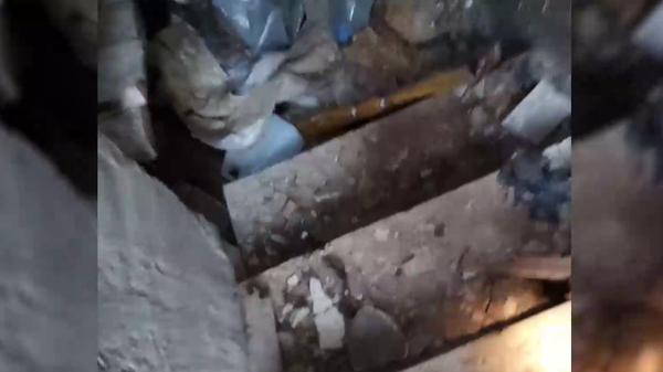 Still from grizzly video of torture chamber near Kherson, Ukraine containing body of what Russian investigators fear is a Russian servicemen tortured to death by Ukrainian troops or nationalist formations. - Sputnik International