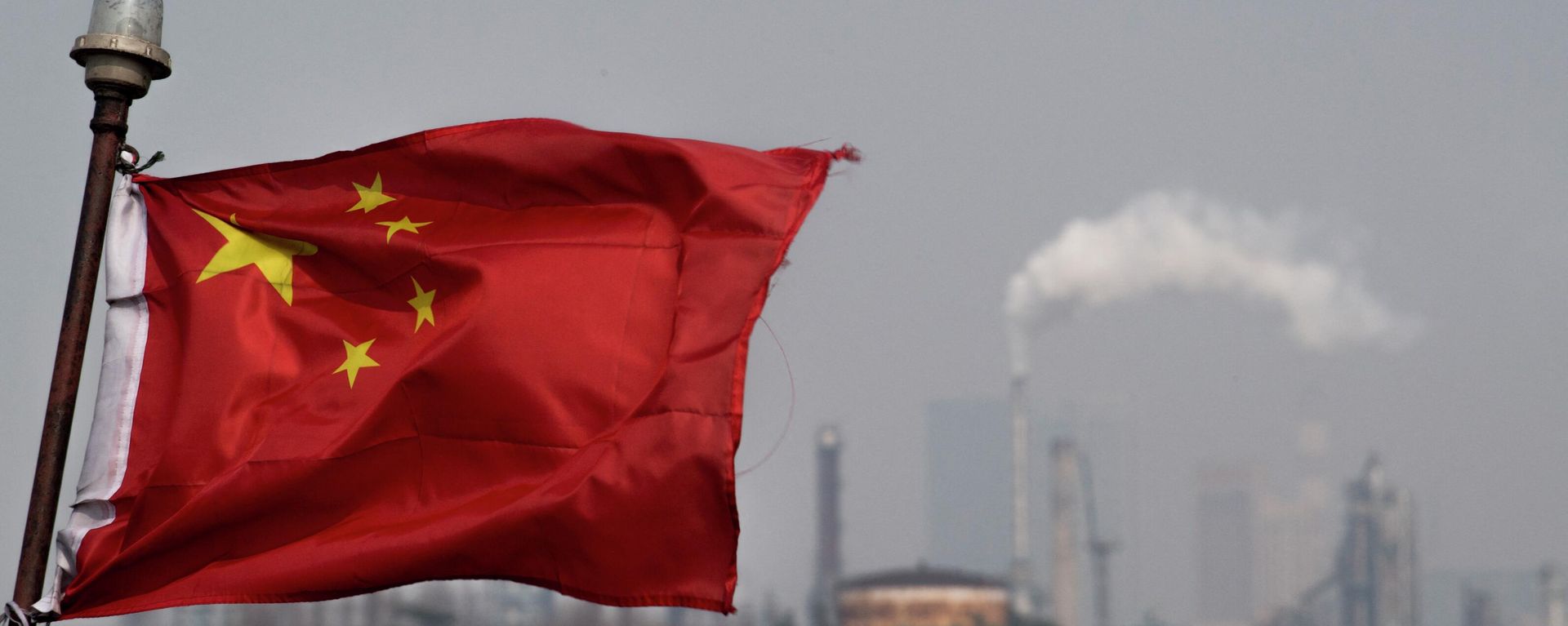 This picture taken on March 22, 2018 shows a Chinese flag fluttering in front of the Shanghai Gaoqiao Company Refinery in Shanghai. - Sputnik International, 1920, 04.05.2022