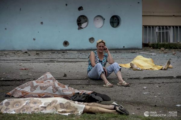 July 2014. Bodies of bystanders killed by a Ukrainian shell in a street in Lugansk. Any civilian in Donbass could have perished from shrapnel wounds at any time during the past eight years. - Sputnik International
