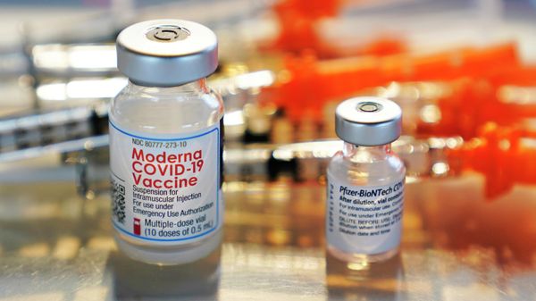 FILE - In this Thursday, Feb. 25, 2021 file photo, vials for the Moderna and Pfizer COVID-19 vaccines  - Sputnik International