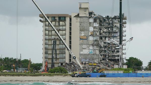 A Florida Fish and Wildlife Conservation law enforcement boat patrols in the ocean in front of search and rescue efforts at the Champlain Towers South condo building, where scores of people remain missing almost a week after it partially collapsed, Wednesday, June 30, 2021, in Surfside, Fla. - Sputnik International