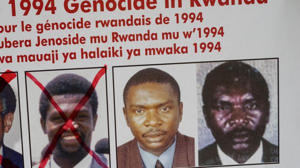 A picture taken on May 19, 2020, shows the faces of Protais Mpiranya, one of the key suspects in the 1994 Rwandan genocide, on a wanted poster on the wall at the Genocide Fugitive Tracking Unit office in Kigali, Rwanda. - Sputnik International