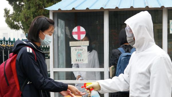 A schoolgirl wearing face mask, disinfects her hands before entering the Kumsong Secondary School No. 2 in the morning in Pyongyang, North Korea, on Nov. 3, 2021. - Sputnik International