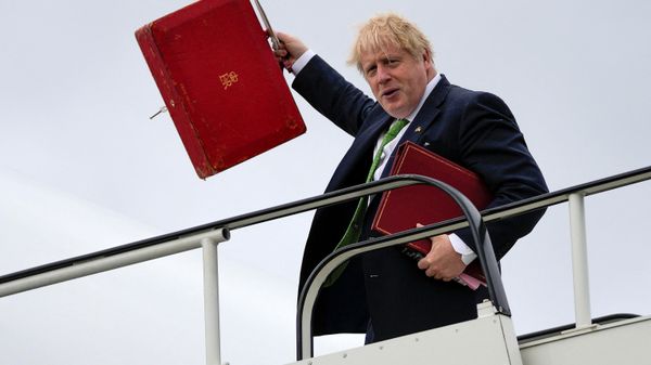 Britain's Prime Minister Boris Johnson waves with his his ministerial red box as he boards an aircraft at London Stansted airport, on May 11, 2022 - Sputnik International