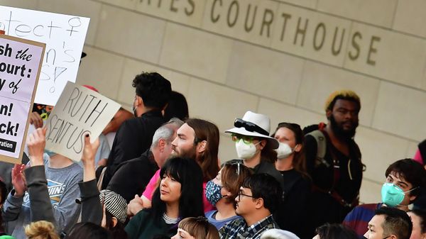 A person holds up a sign reading Ruth Sent Us as  pro-choice activists gather outside the US Courthouse to defend abortion rights in downtown Los Angeles on May 3, 2022 - Sputnik International