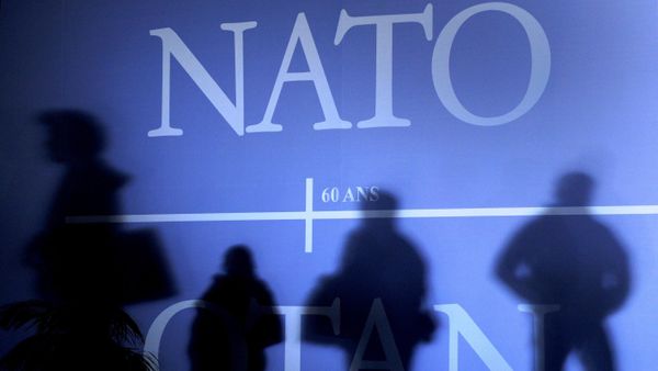 This April 2, 2009 file photo shows shadows cast on a wall decorated with the NATO logo and flags of NATO countries in Strasbourg, eastern France, before the start of the NATO summit which marked the organisation's 60th anniversary. - Sputnik International