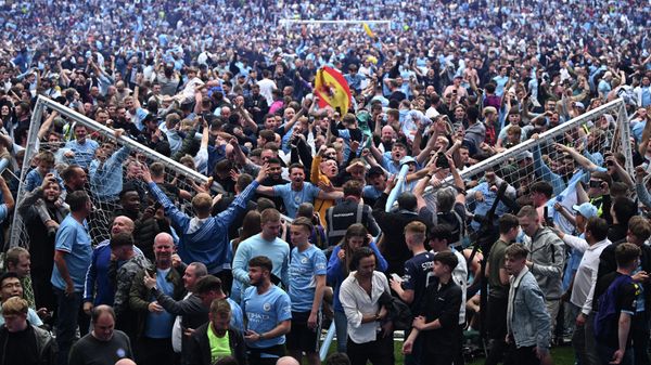 Manchester City's fans celebrate as they invade the pitch at the end of the English Premier League football match between Manchester City and Aston Villa at the Etihad Stadium in Manchester, north west England, on May 22, 2022. Manchester City's fans celebrate as they invade the pitch at the end of the English Premier League football match between Manchester City and Aston Villa at the Etihad Stadium in Manchester, north west England, on May 22, 2022. - Sputnik International