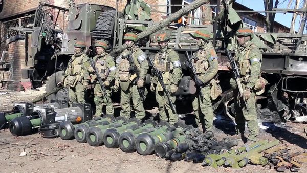 In this handout video grab released by the Russian Defence Ministry, Russian servicemen are pictured by military equipment captured by Russian troops during Russia's military operation in Ukraine, near the village of Huta-Mezhyhirska, in Ukraine - Sputnik International