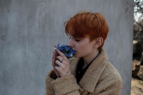 Sophia smells flowers given to her by her maternal grandmother Lydia, in the village of Olhovoye in the Lugansk People's Republic. Sophia, her mother Irina, and father Artyom haven't seen Irina's mother Lydia since 2015. - Sputnik International
