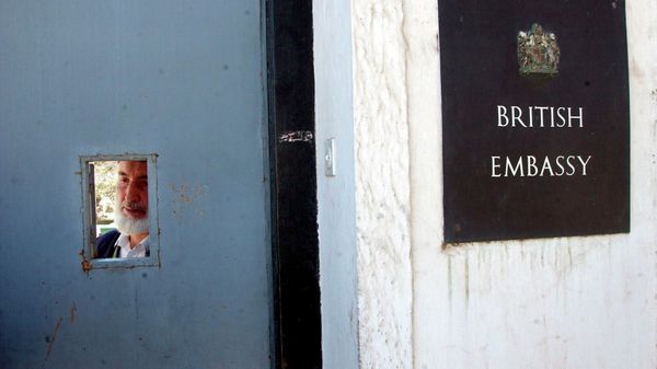 Door keeper Said Afzal looks through the entrance from inside of the British Embassy in Kabul on Friday, Nov.23, 2001 - Sputnik International