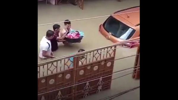 Heartwarming picture from Silchar Floods! 
This video of a father crossing the waters with his newborn baby in Silchar reminds of Vasudeva crossing river Yamuna taking newborn Bhagwan Krishna over his head!  - Sputnik International
