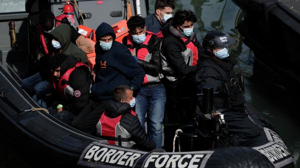 People thought to be migrants who undertook the crossing from France in small boats and were picked up in the Channel, arrive to be disembarked from a small transfer boat which ferried them from a larger British border force vessel that didn't come into the port, in Dover, south east England, Friday, June 17, 2022 - Sputnik International
