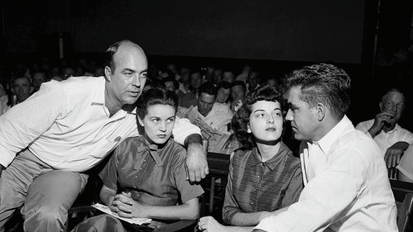 FILE - In this Sept. 23, 1955, file photo, J.W. Milam, left, his wife, second from left, Roy Bryant, far right, and his wife, Carolyn Bryant, sit together in a courtroom in Sumner, Miss. Bryant and his half-brother Milam were charged with murder but acquitted in the kidnapping and torture slaying of 14-year-old black teen Emmett Till in 1955 after he allegedly whistled at Carolyn Bryant. A team searching the basement of a Mississippi courthouse for evidence about the lynching of Black teenager Emmett Till has found the unserved warrant in June 2022 charging a white woman in his kidnapping in 1955, and relatives of the victim want authorities to finally arrest her nearly 70 years later.  - Sputnik International