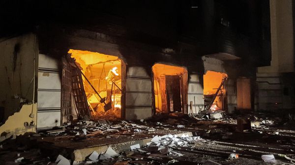 This picture taken early on July 2, 2022 shows a fire inside the building used by Libya's Tobruk-based parliament building in the country's east, lit up by protesters who broke inside while demonstrating against deteriorating living conditions and political deadlock. - Sputnik International