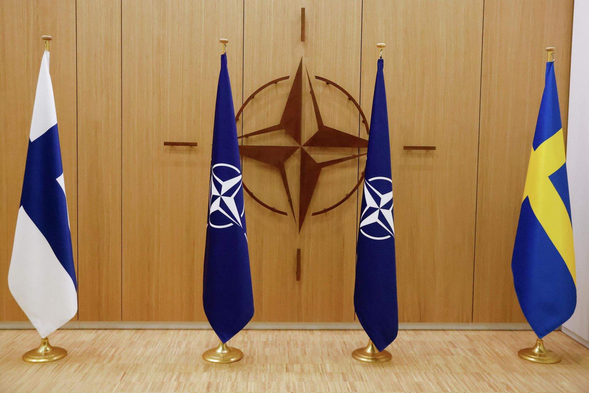 Flags of Finland, left, NATO and Sweden, right, are displayed during a ceremony to mark Sweden's and Finland's application for membership in Brussels, Belgium, Wednesday May 18, 2022. NATO Secretary-General Jens Stoltenberg said that the military alliance stands ready to seize a historic moment and move quickly on allowing Finland and Sweden to join its ranks, after the two countries submitted their membership requests. (Johanna Geron/Pool via AP) - Sputnik International, 1920, 21.01.2023
