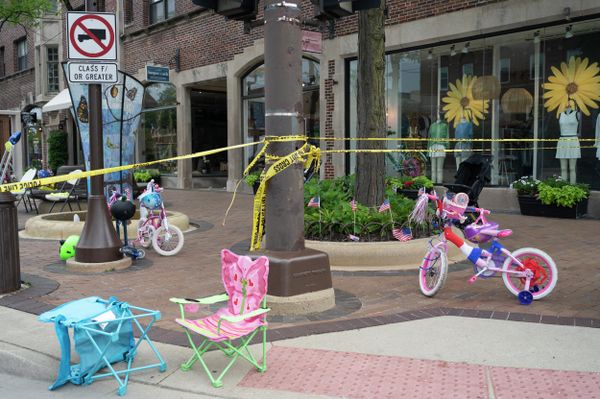 Police crime tape seen around an area where children's bicycles and baby strollers stand near the scene of the Fourth of July parade shooting in Highland Park, Illinois on July 4, 2022. - Sputnik International