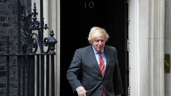 Britain's Prime Minister Boris Johnson walks out the door to greet French President Emmanuel Macron at No.10 Downing Street in central London on June 18, 2020 - Sputnik International