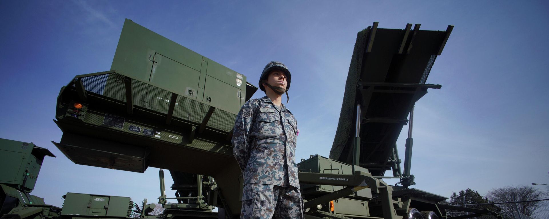 In this Jan. 18, 2018, file photo, a member of the Japan Ground Self-Defense Force stands guard next to a surface-to-air Patriot Advanced Capability-3 (PAC-3) missile interceptor launcher vehicle at Narashino Exercise Area in Funabashi, east of Tokyo.  - Sputnik International, 1920, 18.09.2026